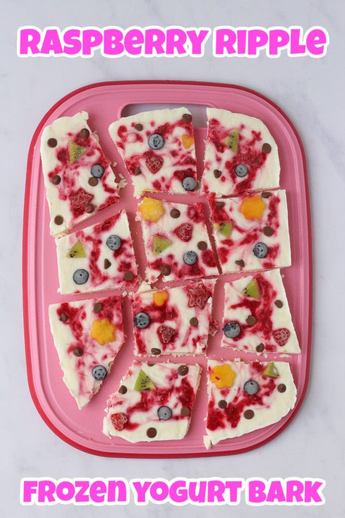 Raspberry Ripple Fro Yo cut into pieces and arranged on a pink chopping board.