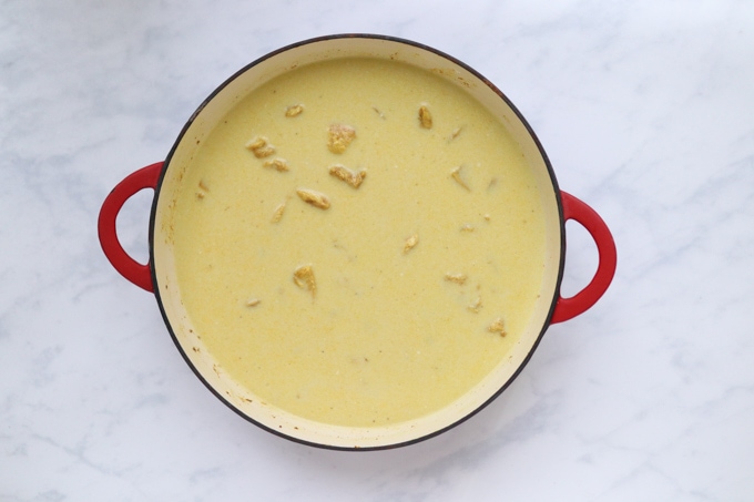 the coconut milk, chicken stock and rice added to the pan with the rest of the ingredients.