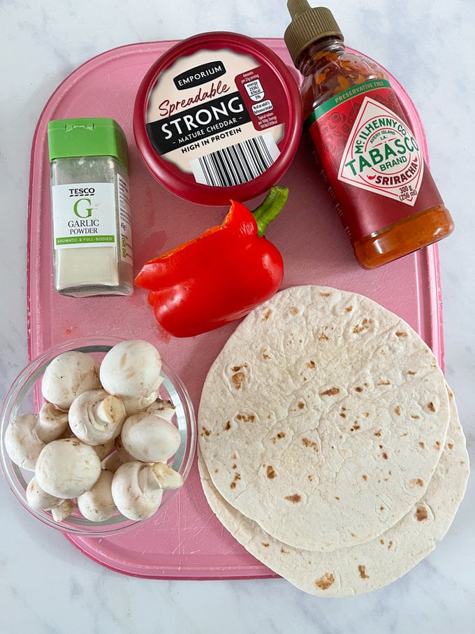 Ingredient's displayed on a pink chopping board.