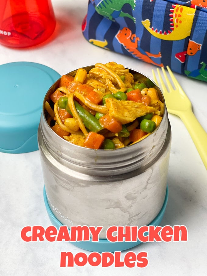 Back-To- School Lunchbox Ideas Creamy Chicken Noodles packed into an aluminum kids food flask with a plastic fork and a lunch bag in the background.