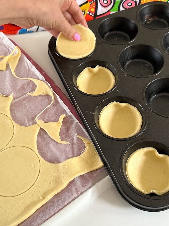 Cut circles being out into a greased muffin or cupcake baking tin.