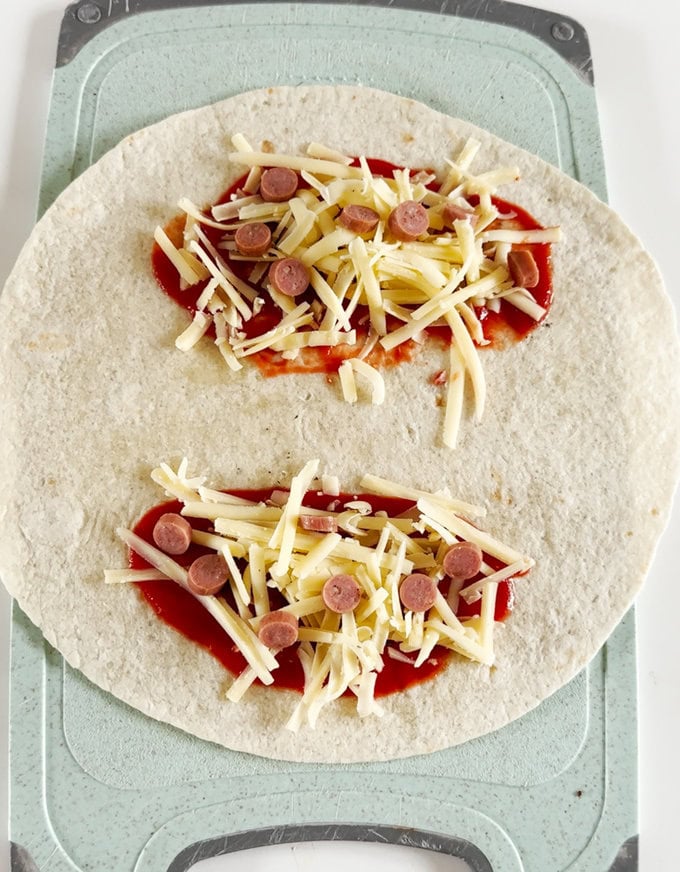 Chopped peperami being added to the wrap.