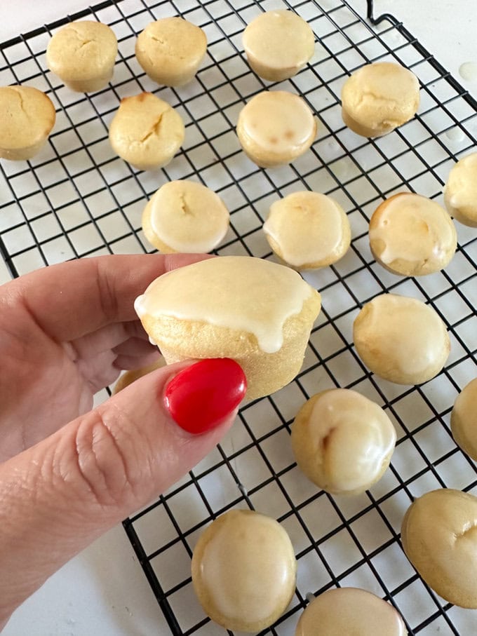 Icing being added to the top of the muffins.