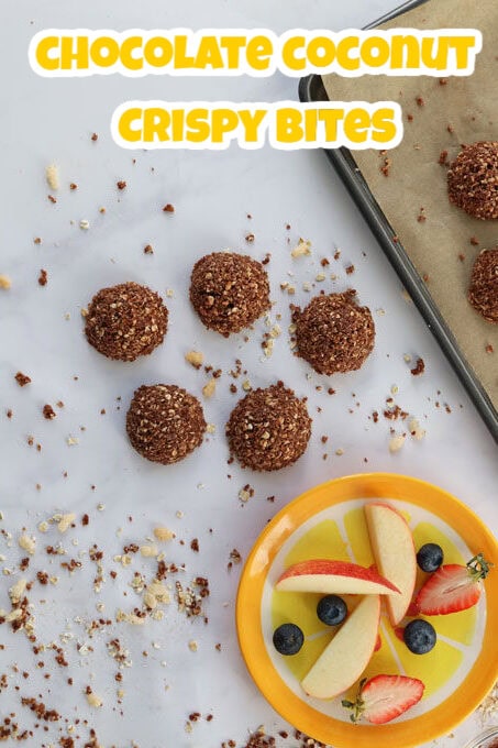 Chocolate coconut crispy bites served on a baking tray.