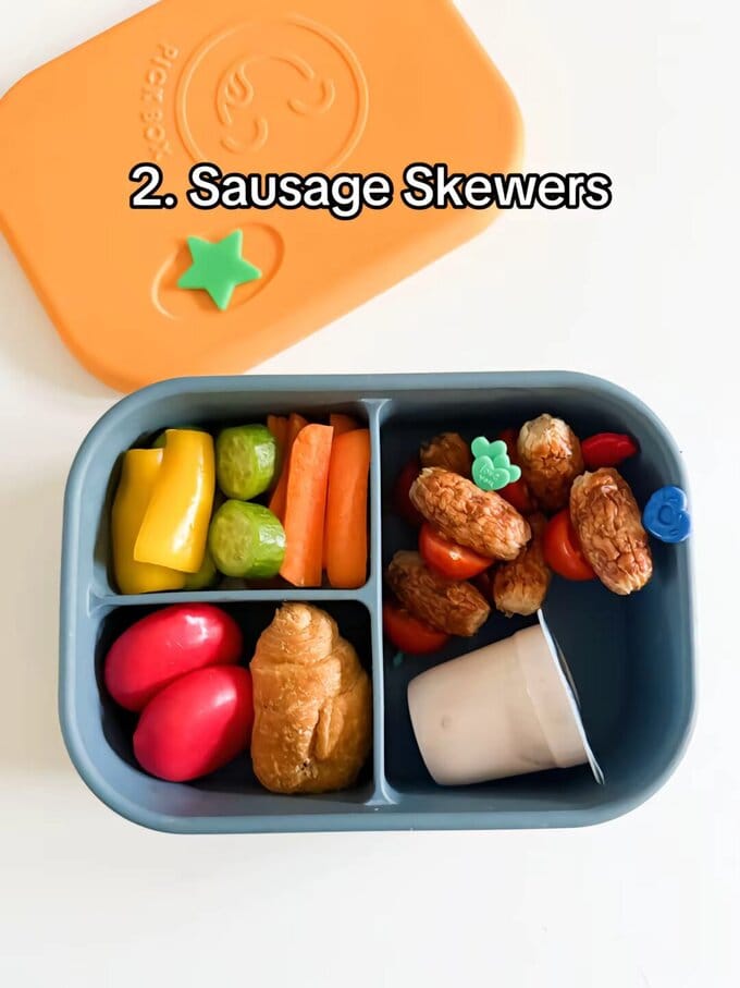 Sausage skewers served on Bright Pick sticks in a kids blue lunch box.